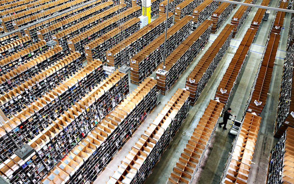 Germany Is Amazon's Second Biggest Market...BRIESELANG, GERMANY - SEPTEMBER 04:  A worker pushes a cart among shelves lined with goods at an Amazon warehouse on September 4, 2014 in Brieselang, Germany. Germany is online retailer Amazon's second largest market after the USA. Amazon is currently in a standoff with several book publishers over sales conditions and prices for e-books, and hundreds of authors in the US and Europe have written letters in support of the publishers.  (Photo by Sean Gallup/Getty Images)